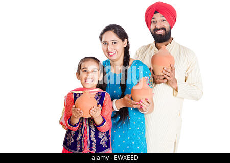 indian Punjabi Parents and daughter Saving money Piggy Bank Stock Photo