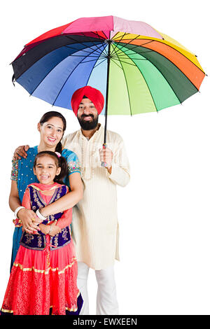 indian Punjabi Parents and daughter Rain Protection Umbrella Stock Photo