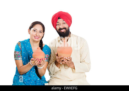 2 indian Punjabi Married Couple Saving money Piggy Bank Stock Photo