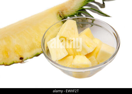 Pineapple cubes on bowl on white background Stock Photo
