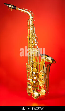 Alto saxophone in full length on red background Stock Photo