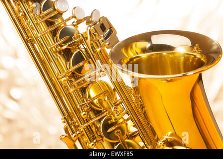 Saxophone with bell and keys on silver background Stock Photo