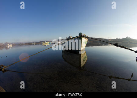 Beautiful dynamic/ symetrical reflections of Diapori boats and Kontias landscape scenery on the water. Diapori, Lemnos. Stock Photo