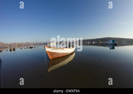 Beautiful dynamic/ symmetric reflections of Diapori boats and Kontias landscape scenery on the water. Diapori, Lemnos. Stock Photo