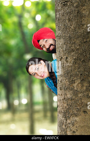 2 indian Punjabi Married Couple park Hide and Seek enjoy Stock Photo