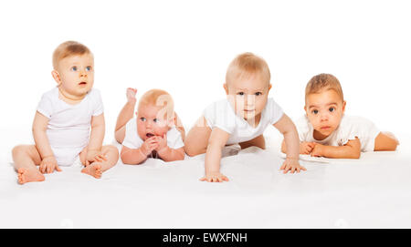 Cute babies crawl in a row wearing white bodysuit Stock Photo