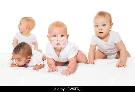 Curious looking babies crawl in a row together Stock Photo