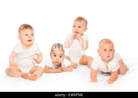 Curious looking group of babies on the white Stock Photo