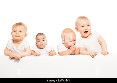 Cute babies stand in a row on the white background Stock Photo