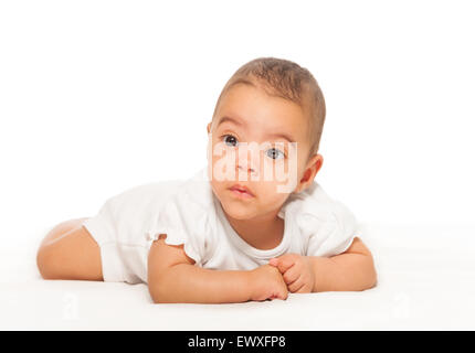 Serious looking African baby in white bodysuit Stock Photo