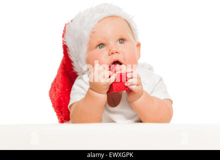 Cute baby in red Christmas hat with small gift box Stock Photo