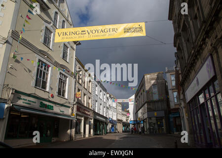 Threatening grey rain clouds over town centre street, Falmouth, Cornwall, England Viking Voyagers advertising banner Stock Photo
