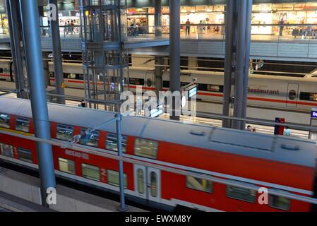 Inside Berlin Hauptbahnhof central railway station with trains passing through, Germany Stock Photo