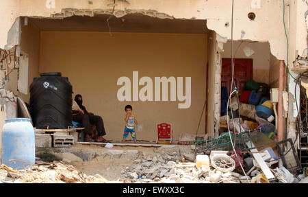 Palestinian family sit in the remains of their bombed out house after ...