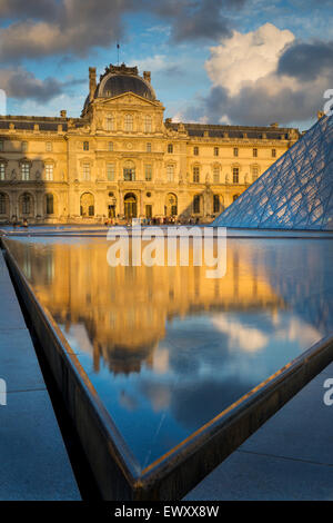Colorful clouds at sunset over the courtyard of Musee du Louvre, Paris, France Stock Photo