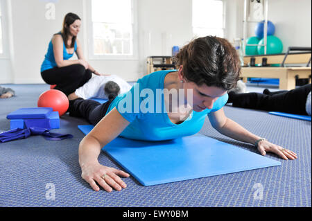 Young woman taking part in a Pilates class. Stock Photo