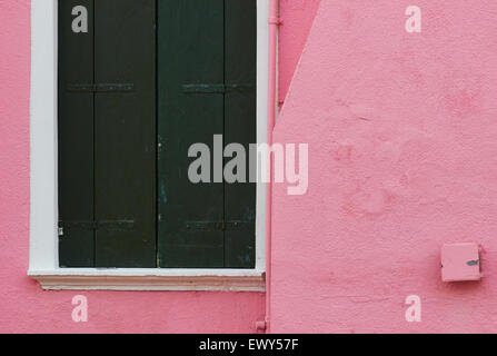 Pink painted wall and closed green shutters on house Burano Venetian Lagoon Veneto Italy Europe Stock Photo