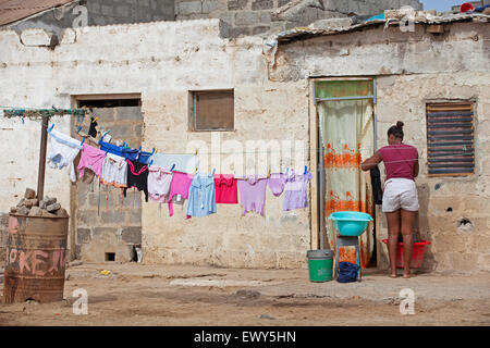 Creole woman washing clothes at home in the village Palmeira on the island of Sal, Cape Verde / Cabo Verde, Western Africa Stock Photo