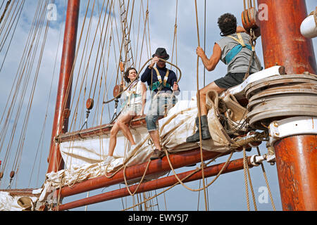 Tourists working on board of the Oosterschelde, three-masted schooner sailing the Atlantic Ocean near Cape Verde / Cabo Verde Stock Photo