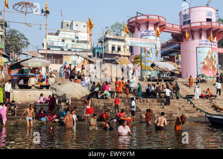 Praying and taking to the holy waters at Dashashwamedh Ghat the most famous and central bathing ghat. The culture of Varanasi is closely associated with the River Ganges and the river's religious importance.It is 'the religious capital of India'and an important pilgrimage destination.Varanasi, also known as Benares, an ancient city, one of the world's oldest continually inhabited cities, situated on the left/west bank of the sacred Ganges River. Regarded as holy by Hindus, Buddhists, and Jains.  Uttar Pradesh State, India, Asia. Stock Photo