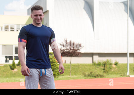 Young Man In Sports Clothing After Outdoor Exercises Stock Photo