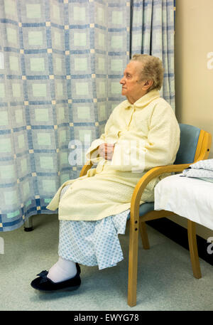 Elderly lady in her nineties waiting to be taken to operating theatre for surgery in day unit in NHS hospital, England. UK Stock Photo