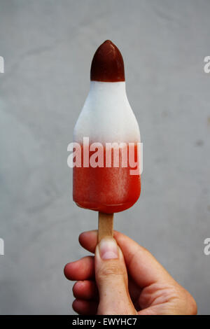 Close-up of a boy holding an ice lolly Stock Photo