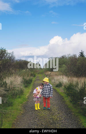 Two children standing on a path Stock Photo