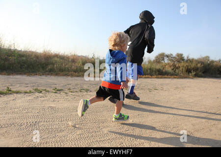 Rear view of two boys running Stock Photo