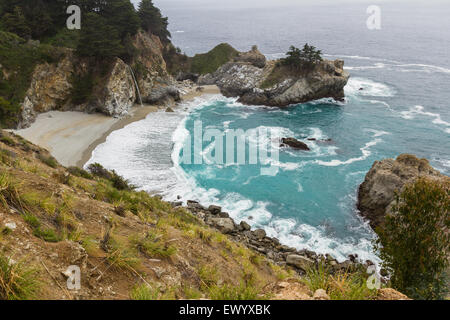 Waterfall in Julia Pfeifer Burns State Park, on a cloudy day, with turquoise water Stock Photo