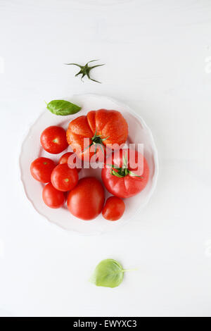 ripe tomatoes on plate, top view Stock Photo