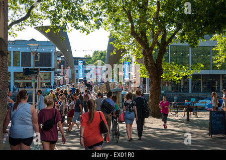 People crossing Pero's Bridge  St Augustine's Reach in Bristol Harbour, Bristol, England. Stock Photo