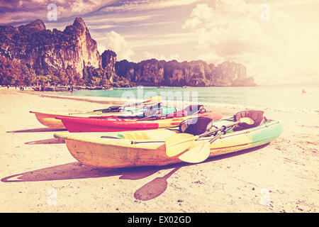 Retro toned kayaks on a tropical beach. Active holidays background. Stock Photo