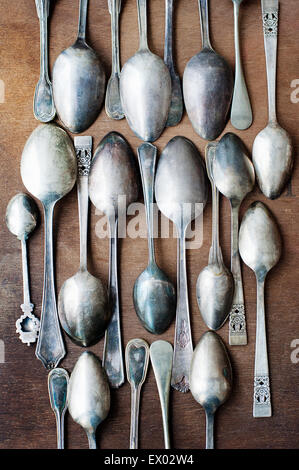 Still life with rows of vintage spoons on table Stock Photo