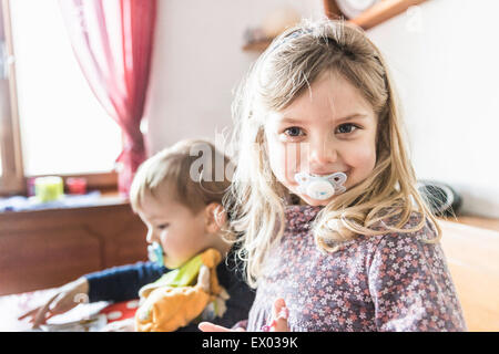 Children with pacifiers playing Stock Photo