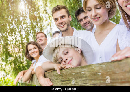 Group of people standing behind fence, portrait Stock Photo