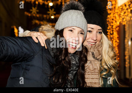 Two mid adult women wearing hats, smiling Stock Photo