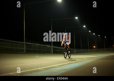 Cyclist cycling on track at velodrome, outdoors Stock Photo