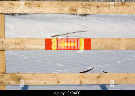 colourful arrow sign on wooden fence Stock Photo