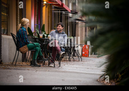 Couple having coffee at sidewalk cafe, Savannah, Georgia, USA Stock Photo