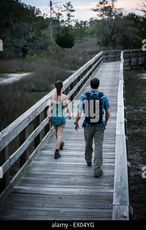 Hikers crossing bridge, Skidaway Island State Park , Savannah, Georgia, USA Stock Photo