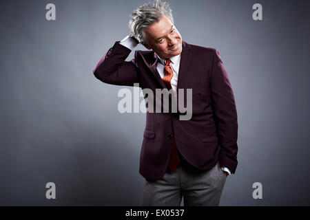 Studio portrait of mature businessman scratching his head Stock Photo