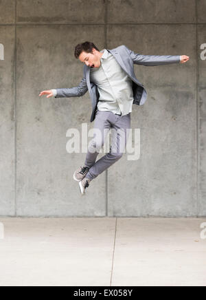 Businessman jumping mid air Stock Photo