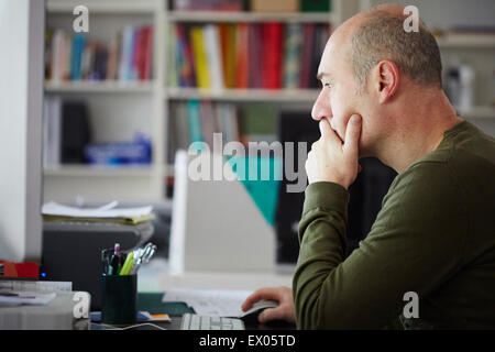 Mature man working in creative studio Stock Photo