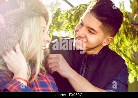 Young couple smiling, woman wearing hat Stock Photo