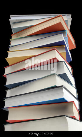 A stack of books in front of black background Stock Photo