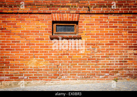 Red brick wall with a window Stock Photo