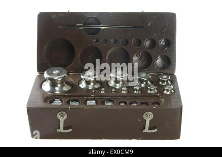 set of small weights for weighing in a wooden box isolated on white background Stock Photo