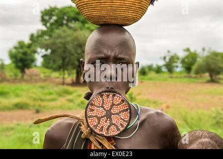 Woman from the african tribe Mursi with a big lip plate. Stock Photo