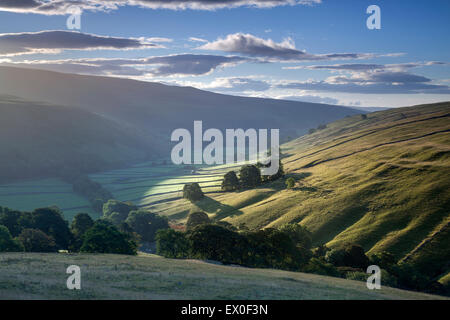 View down the valley of Littondale at sunrise in summer, Litton, Littondale, Yorkshire Dales, North Yorkshire, UK Stock Photo